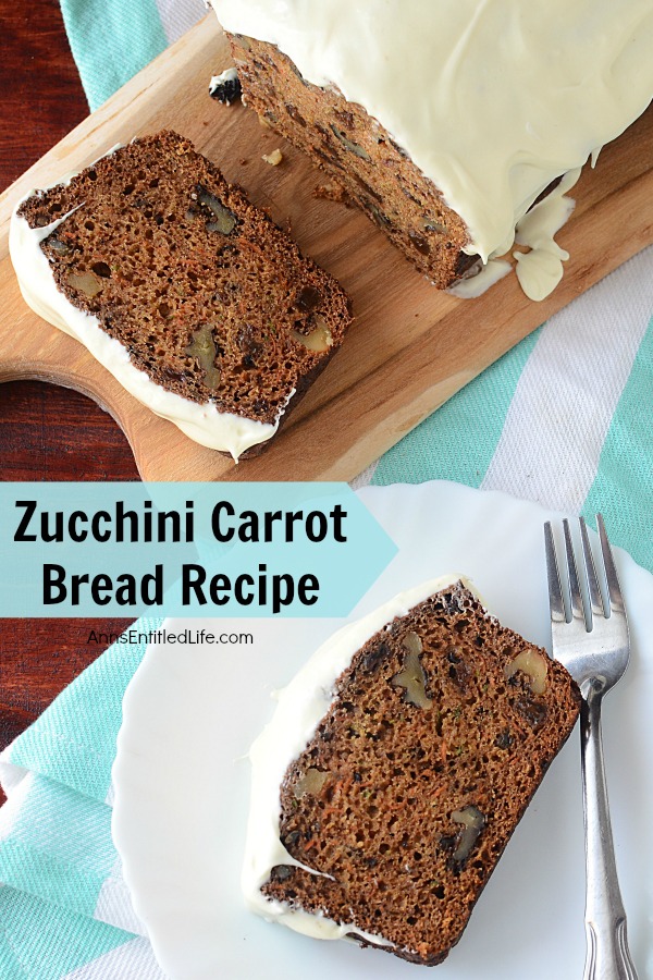 frosted zucchini carrot bread on a white plate with fork, remaining loaf on a butcher block cutting board