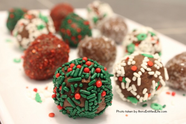 Chocolate Raspberry Truffle Bites Recipe. These simple to make chocolate truffles come with a fun raspberry surprise inside! A fun addition to your holiday cookie platter, this Chocolate Raspberry Truffle Bites Recipe is truly tasty.