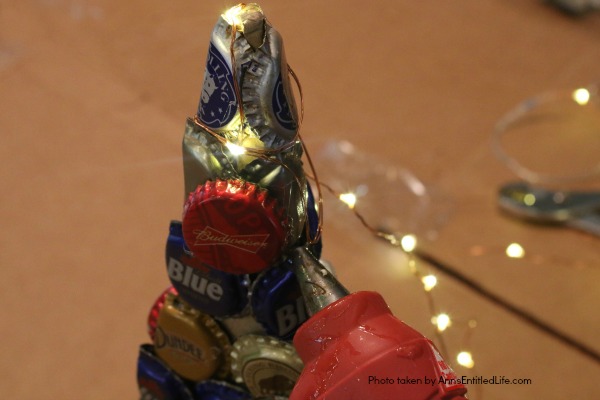 Bottle Cap Christmas Tree DIY Tutorial. Follow the step by step instructions in this Bottle Cap Christmas Tree DIY Tutorial to make a lighted bottle cap Christmas tree. Use your pop caps or beer caps to make this unique, and beautiful, holiday craft!