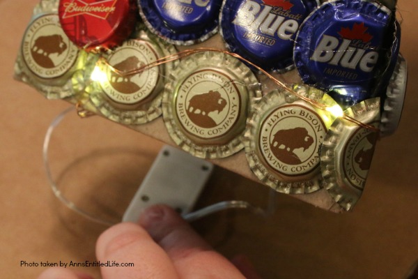 Bottle Cap Christmas Tree DIY Tutorial. Follow the step by step instructions in this Bottle Cap Christmas Tree DIY Tutorial to make a lighted bottle cap Christmas tree. Use your pop caps or beer caps to make this unique, and beautiful, holiday craft!