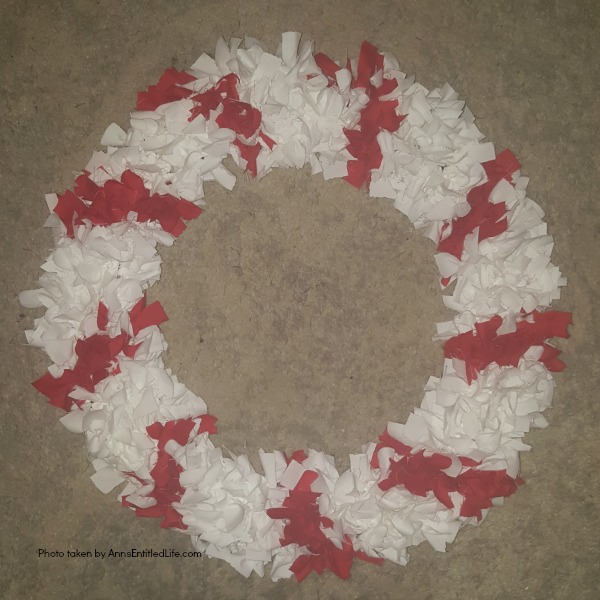 Candy Cane Wreath DIY Tutorial. Make your own no-sew Candy Cane using these easy step by step instructions. This cute holiday decor is perfect for Christmas, Valentine's Day, or any day! Simple and inexpensive to make, this easy Candy Cane Wreath DIY Tutorial will show you how to add a marvelous touch of whimsy to your holiday decor.