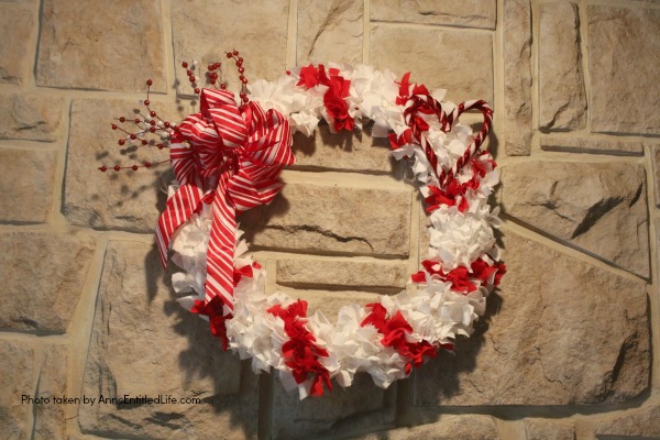 Candy Cane Wreath DIY Tutorial. Make your own no-sew Candy Cane using these easy step by step instructions. This cute holiday decor is perfect for Christmas, Valentine's Day, or any day! Simple and inexpensive to make, this easy Candy Cane Wreath DIY Tutorial will show you how to add a marvelous touch of whimsy to your holiday decor.