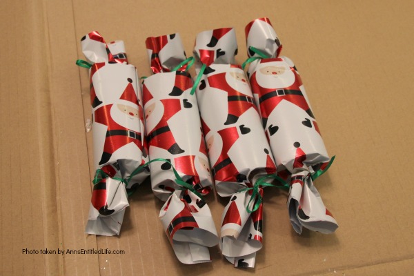 How to Make Christmas Crackers. You can easily make a home version of the popular United Kingdom Christmas Crackers with this step by step tutorial. Great for table favors, decor, and party fun, these Christmas Crackers will delight children and adults at your holiday dinner or party.