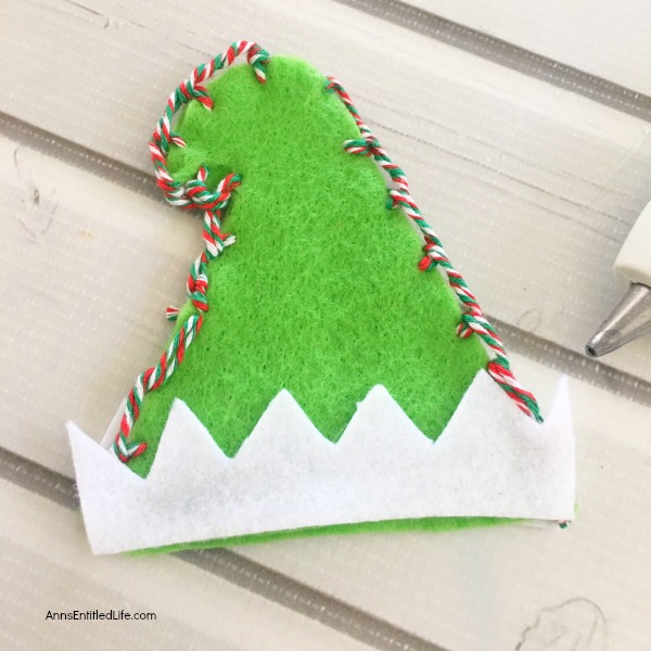 Elf Mason Jar Lid Ornament DIY. This easy to make Elf Mason jar lid ornament is simply adorable. This step by step tutorial has easy to follow directions so you can make one for your tree, to give as a gift, or to place on top of a present as a little something extra.