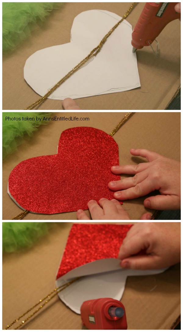 The Grinch Inspired Wreath DIY Tutorial. A beautiful Mr. Grinch inspired wreath sure to make even the coldest heart burst! This step by step tutorial is complete with (free) pdfs for the hat and heart for you to print and make exact. This wreath will look great on your front door, over your mantel, or on a wall. Truly unique holiday decor!