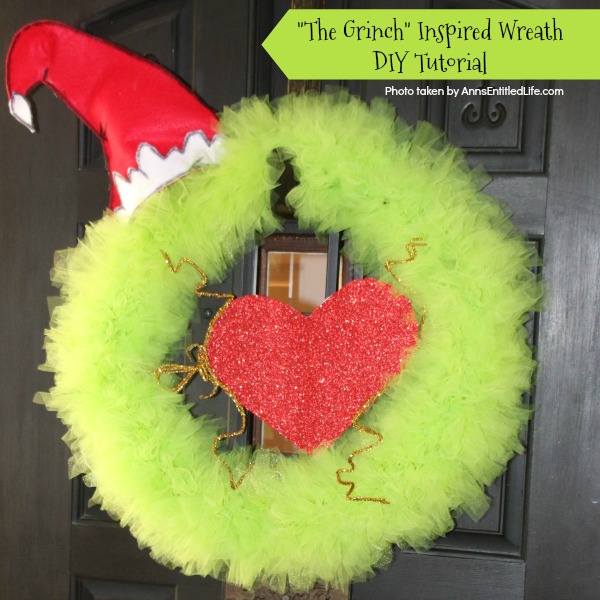 The Grinch Inspired Wreath DIY Tutorial. A beautiful Mr. Grinch inspired wreath sure to make even the coldest heart burst! This step by step tutorial is complete with (free) pdfs for the hat and heart for you to print and make exact. This wreath will look great on your front door, over your mantel, or on a wall. Truly unique holiday decor!