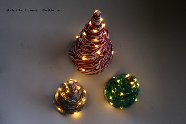 Easy Lighted Ribbon Christmas Tree. This 15 minute craft is simple to make, and highly customizable. This Easy Lighted Ribbon Christmas Tree will dress up your Christmas table, light up your mantel, or just smile as you walk by them. Only you will know how quick and easy these little trees are to put together.