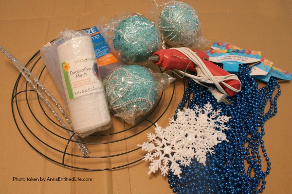 Snowflake Bead Wreath Craft DIY. This is a beautiful snowflake wreath that is perfect for door decor in the chilly winter months. You can fully customize this snowflake bead wreath for color, and ornaments. Simple to make, this lovely Snowflake Bead Wreath Craft is a real conversation piece.