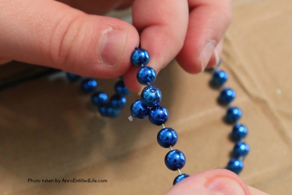 Snowflake Bead Wreath Craft DIY. This is a beautiful snowflake wreath that is perfect for door decor in the chilly winter months. You can fully customize this snowflake bead wreath for color, and ornaments. Simple to make, this lovely Snowflake Bead Wreath Craft is a real conversation piece.