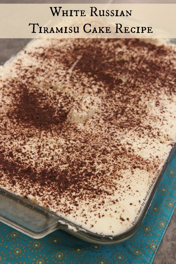 An whole pan of white Russian tiramisu cake that is uncut.