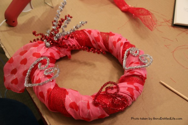 Dollar Store Craft: Heart Wreath. This simple to make heart wreath is made using dollar store finds. It comes together in under 15 minutes, and it a wonderful, inexpensive heart décor. Perfect for Valentine’s Day, Sweetest Day, or any occasion where heart décor is wanted.