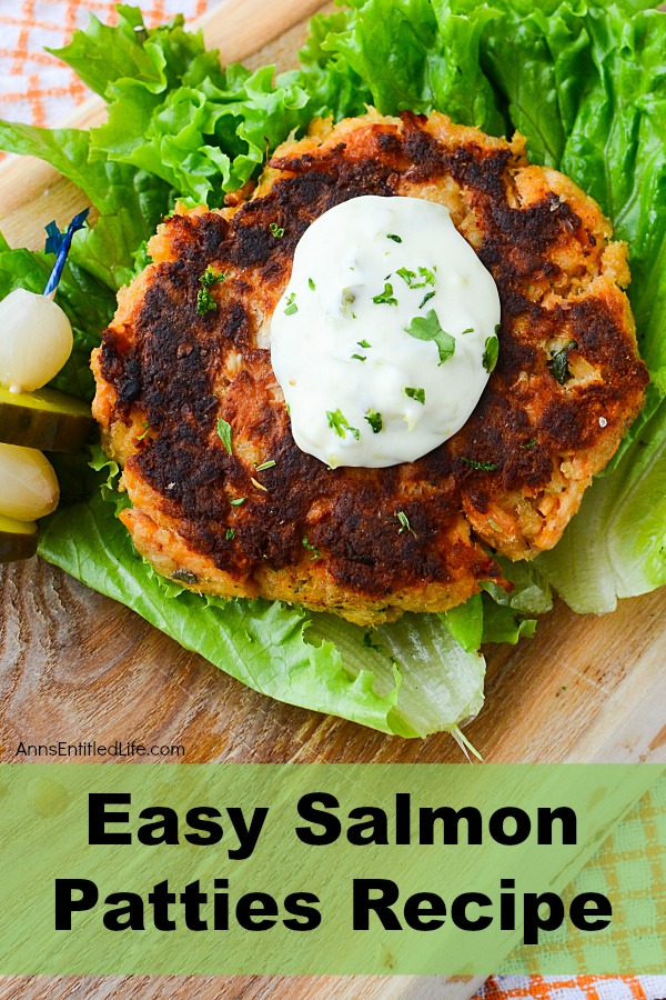 Cooked samon patties on a bun with tartar sauce, chives, and lettuce