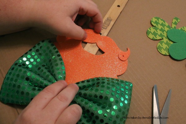 St. Patrick's Day Door Hanger DIY. Make your own St. Patty's Day door décor! This leprechaun inspired, easy DIY tutorial comes together quickly when you follow these step by step craft instructions. This St. Patrick’s Day Door Hanger DIY project is simply adorable!