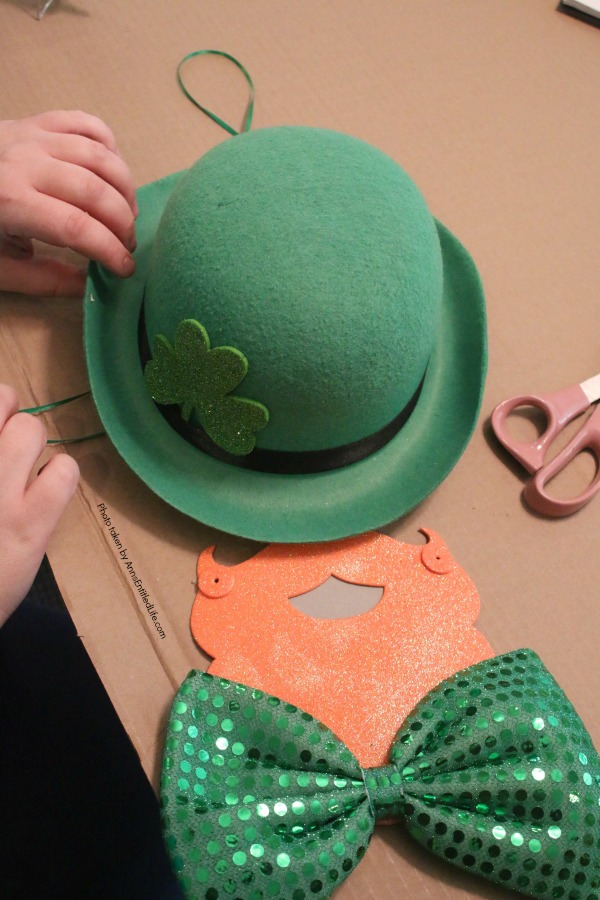 St. Patrick's Day Door Hanger DIY. Make your own St. Patty's Day door décor! This leprechaun inspired, easy DIY tutorial comes together quickly when you follow these step by step craft instructions. This St. Patrick’s Day Door Hanger DIY project is simply adorable!