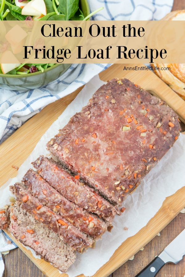 overhead view of a meatloaf on a cutting board. There is a salad in the upper left.