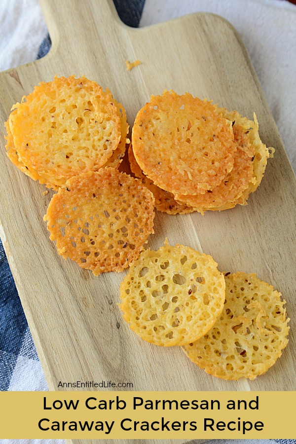 cheese cracker chips on a wooden cutting board over a blue kitchen towel