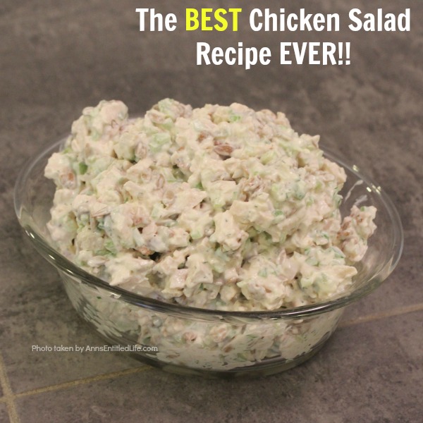 chicken salad in a glass serving bowl on top of a graey slate kitchen island