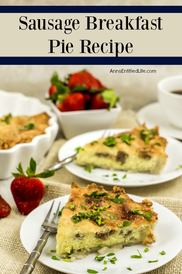 plated sauage breakfast pie on white dishes atop a tan placemat, coffee, strawberries and silverware accompany the dish