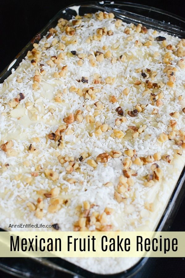 A baked and frosted Mexican fruit cake in a clear baking pan