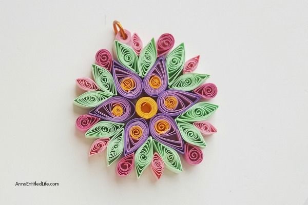 How to Make a Flower Quilling Pendant Necklace. Use these easy step by step instructions to make a beautiful flower pendant with quilling paper strips. This lovely pendant can be customized to any color to personalize your flower quilling pendant necklace to your exact taste. If you are interested in making quilling jewelry, start here!