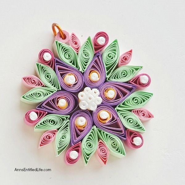 How to Make a Flower Quilling Pendant Necklace. Use these easy step by step instructions to make a beautiful flower pendant with quilling paper strips. This lovely pendant can be customized to any color to personalize your flower quilling pendant necklace to your exact taste. If you are interested in making quilling jewelry, start here!