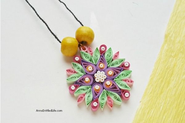 How to Make a Flower Quilling Pendant Necklace. Use these easy step by step instructions to make a beautiful flower pendant with quilling paper strips. This lovely pendant can be customized to any color to personalize your flower quilling pendant necklace to your exact taste. If you are interested in making quilling jewelry, start here!