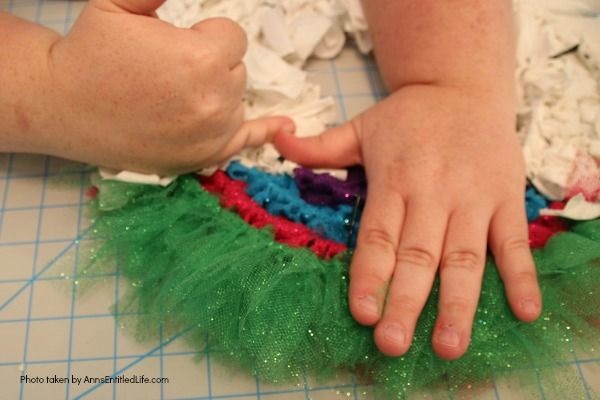 Easy Unicorn Wreath DIY. This simple to make sparkly unicorn rag wreath is an adorable and whimsical take on a unicorn wreath. Follow the step-by-step instructions of this detailed tutorial to make this fun homemade wreath. From the multicolored mane, sparkly white coat, and fanciful ears and cone, this delightful unicorn wreath is a playful take on the great mythical creature.