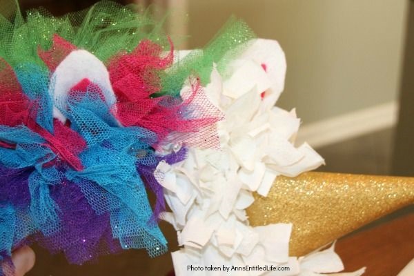 Easy Unicorn Wreath DIY. This simple to make sparkly unicorn rag wreath is an adorable and whimsical take on a unicorn wreath. Follow the step-by-step instructions of this detailed tutorial to make this fun homemade wreath. From the multicolored mane, sparkly white coat, and fanciful ears and cone, this delightful unicorn wreath is a playful take on the great mythical creature.