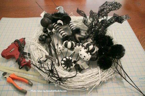 Black and White Witch Wreath DIY. Make your own witch wreath for Halloween this year using these easy step-by-step tutorial instructions. This monochromatic black and white witch's door decor wreath is simple to make, and look oh so elegant. Seriously. Elegant Halloween decor! Who would have thought! Get the straightforward instructions below!