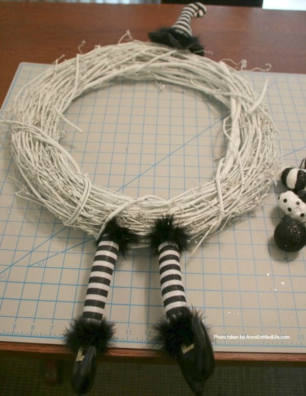 Black and White Witch Wreath DIY. Make your own witch wreath for Halloween this year using these easy step-by-step tutorial instructions. This monochromatic black and white witch's door decor wreath is simple to make, and look oh so elegant. Seriously. Elegant Halloween decor! Who would have thought! Get the straightforward instructions below!