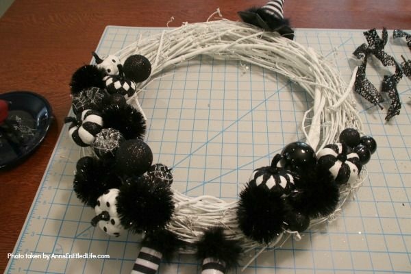 Black and White Witch Wreath DIY. Make your own witch wreath for Halloween this year using these easy step-by-step tutorial instructions. This monochromatic black and white witch's door decor wreath is simple to make, and look oh so elegant. Seriously. Elegant Halloween decor! Who would have thought! Get the straightforward instructions below!