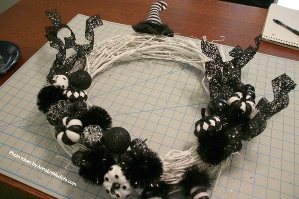 Black and White Witch Wreath DIY. Make your own witch wreath for Halloween this year using these easy step-by-step tutorial instructions. This monochromatic black and white witch's door decor wreath is simple to make, and look oh so elegant. Seriously. Elegant Halloween decor! Who would have thought! Get the straightforward instructions below!