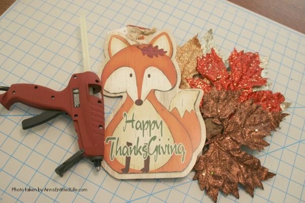 Dollar Store Craft: Easy Thanksgiving Door Hanger DIY. An inexpensive, festive, Thanksgiving door craft perfect for side doors, classroom doors, or anywhere where a flat door hanger is needed.