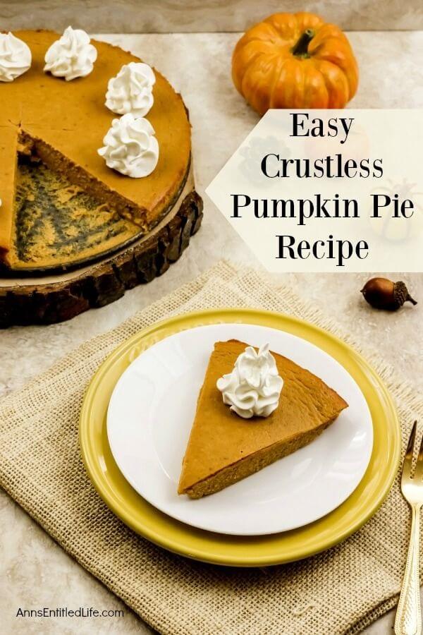 A slice of crustless pumpkin pie on a white plate which is set atop a beige placement. There is a gold fork to the right of the setting. The rest of the pie is on a wooden tray in the upper left. A mini pumpkin and faux acorn are decors around the plate.