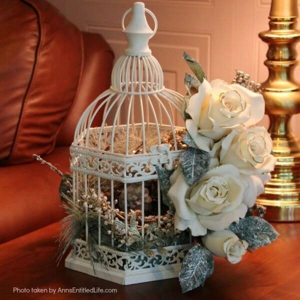 Have an old birdcage lying about that you would like to repurpose into a beautiful decor piece? This wonderful winter white birdcage decorating idea is a lovely DIY decorating piece for the holidays and beyond. This tells the story of a bird that has left the cage to fly south for the winter. His (or her) nest is empty, and he (or she) is off to parts unknown. This is not only a lovely winter piece, it could be used for wedding decor, a centerpiece, a front foyer piece (I always decorate my foyer!) or you could hang it as an empty birdcage in a Florida room or family room.