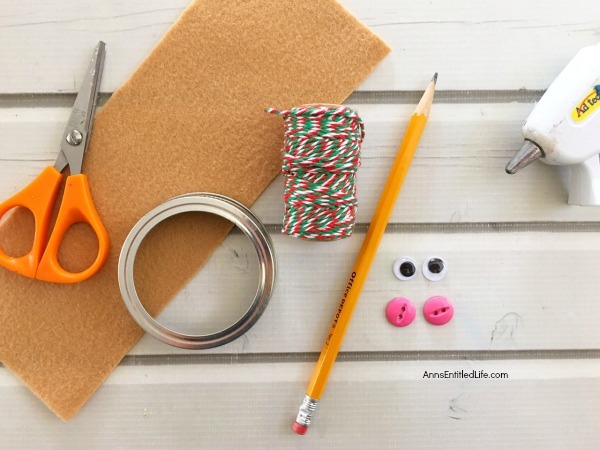 Gingerbread Man Mason Jar Lid Ornament DIY. Give your Christmas tree a personal touch and make your own ornaments this holiday season. Follow these step-by-step tutorial instructions to make this adorable Gingerbread Man Mason Jar Lid Ornament!