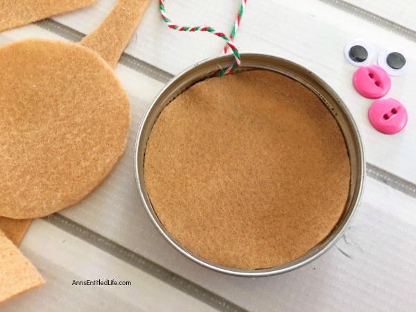 Gingerbread Man Mason Jar Lid Ornament DIY. Give your Christmas tree a personal touch and make your own ornaments this holiday season. Follow these step-by-step tutorial instructions to make this adorable Gingerbread Man Mason Jar Lid Ornament!