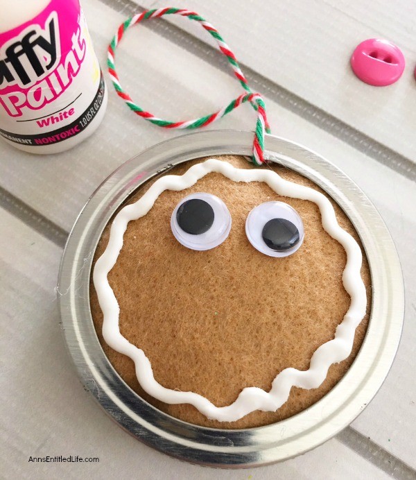 Gingerbread Man Mason Jar Lid Ornament DIY. Give your Christmas tree a personal touch and make your own ornaments this holiday season. Follow these step-by-step tutorial instructions to make this adorable Gingerbread Man Mason Jar Lid Ornament!