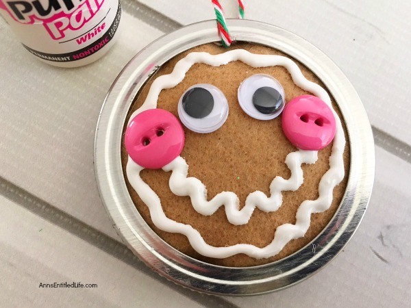 Gingerbread Man Mason Jar Lid Ornament DIY. Give your Christmas tree a personal touch and make your own ornaments this holiday season. Follow these step-by-step tutorial instructions to make this adorable Gingerbread Man Mason Jar Lid Ornament!