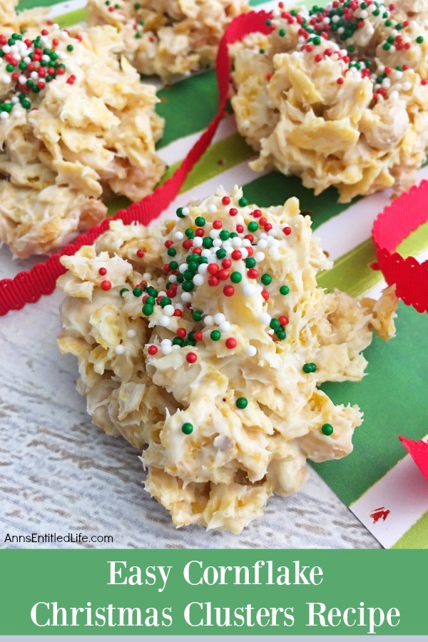 4 cornflakes cluster treats sitting on a green striped Christmas paper, a red ribbon flows over the treats.