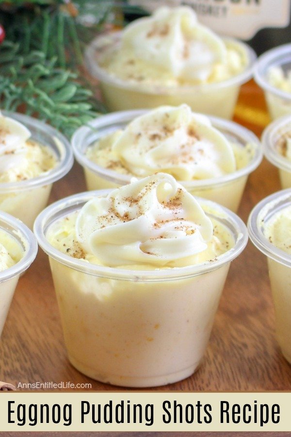 A line-up of eggnog pudding shots in plastic cups on a table