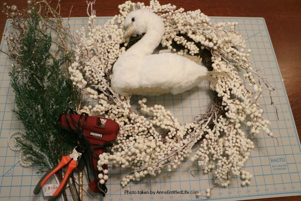 Golden Swan Wreath DIY. This stunning wreath takes only 15 minutes to make! Perfect for so many holidays, party functions (think bridal or shower), or as a year round wreath with a bit of bling, this unusual swan wreath is lovely wall décor or door décor!