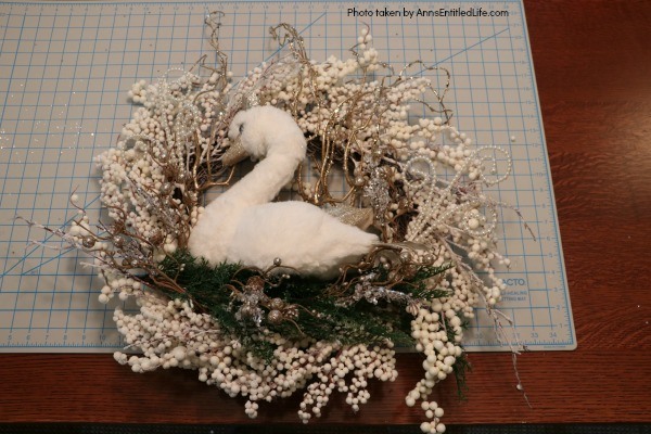 Golden Swan Wreath DIY. This stunning wreath takes only 15 minutes to make! Perfect for so many holidays, party functions (think bridal or shower), or as a year round wreath with a bit of bling, this unusual swan wreath is lovely wall décor or door décor!