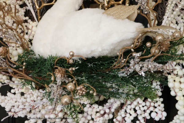 Golden Swan Wreath DIY. This stunning wreath takes only 15 minutes to make! Perfect for so many holidays, party functions (think bridal or shower), or as a year round wreath with a bit of bling, this unusual swan wreath is lovely wall décor or door décor!