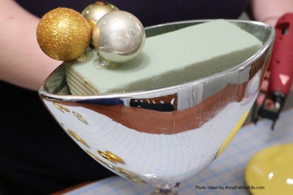 Bubbly New Year's Eve Table Décor. This upcycled New Year's Eve décor is a great celebration centerpiece! You can use this champagne bubbly inspired craft for your champagne party, as an accent at a party bar or as fun décor at any cocktail party - or simply leave it up year-round on your wet bar. Super easy to make, this Bubbly New Year's Eve Table Décor piece can be made in gold, silver, copper, rose gold, or pink champagne colors for a great added sparkle decoration adorning your party tabletop arrangement.