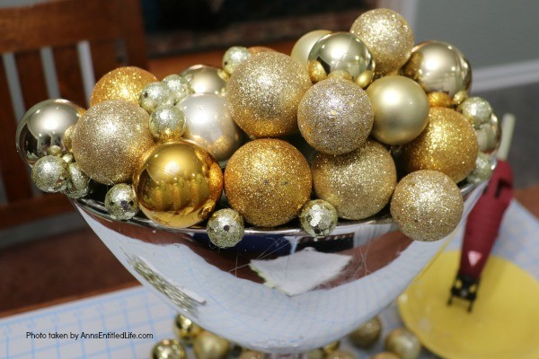 Bubbly New Year's Eve Table Décor. This upcycled New Year's Eve décor is a great celebration centerpiece! You can use this champagne bubbly inspired craft for your champagne party, as an accent at a party bar or as fun décor at any cocktail party - or simply leave it up year-round on your wet bar. Super easy to make, this Bubbly New Year's Eve Table Décor piece can be made in gold, silver, copper, rose gold, or pink champagne colors for a great added sparkle decoration adorning your party tabletop arrangement.