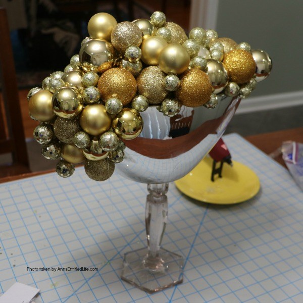 Bubbly New Year's Eve Table Décor. This upcycled New Year's Eve décor is a great celebration centerpiece! You can use this champagne bubbly inspired craft for your champagne party, as an accent at a party bar or as fun décor at any cocktail party - or simply leave it up year-round on your wet bar. Super easy to make, this Bubbly New Year's Eve Table Décor piece can be made in gold, silver, copper, rose gold, or pink champagne colors for a great added sparkle decoration adorning your party tabletop arrangement.