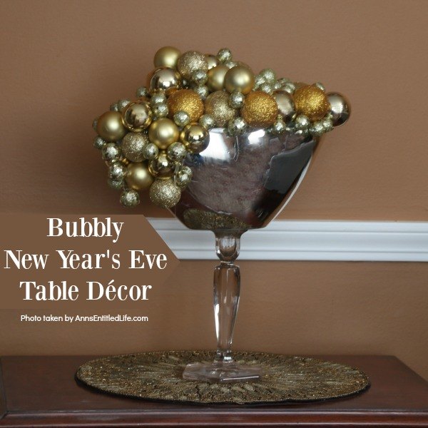 Bubbly New Year's Eve Table Décor. This upcycled New Year's Eve décor is a great celebration centerpiece! You can use this champagne bubbly inspired craft for your champagne party, as an accent at a party bar or as fun décor at any cocktail party - or simply leave it up year-round on your wet bar. Super easy to make, this Bubbly New Year's Eve Table Décor piece can be made in gold, silver, copper, rose gold, or pink champagne colors for a great added sparkle decoration adorning your party tabletop arrangement.