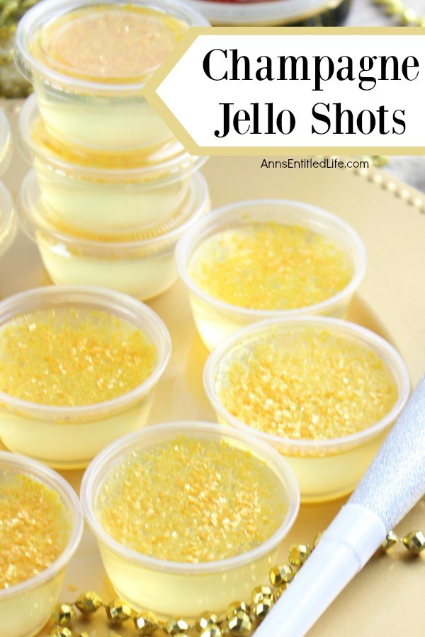 an overhead view of six champagne jello shots in souffle cups set on a gold tray. In the background is a stack of more champagne jello shots.