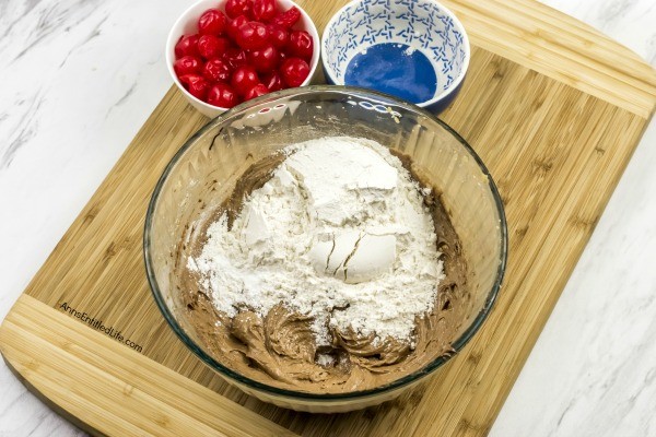 Cherry Cordial Cookies Recipe. A sinfully decadent chocolate cookie surrounds a cherry surprise in the middle! These easy to make cookies are fun and delicious. Your friends and family will love these tasty cookie treats!